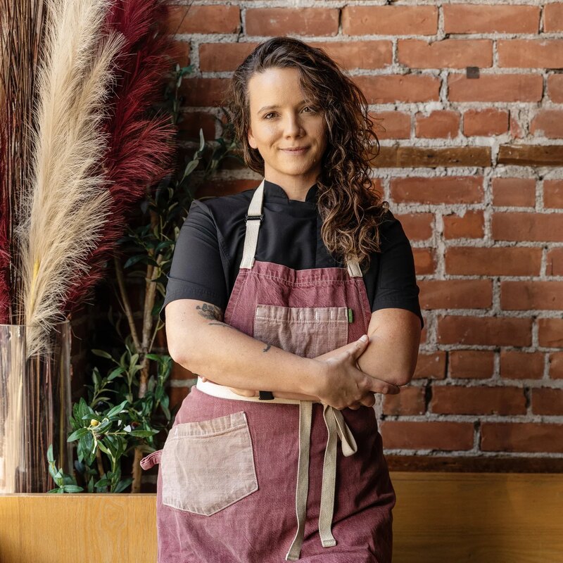 Sarah Welch, chef and partner at Umbo, against a brick wall